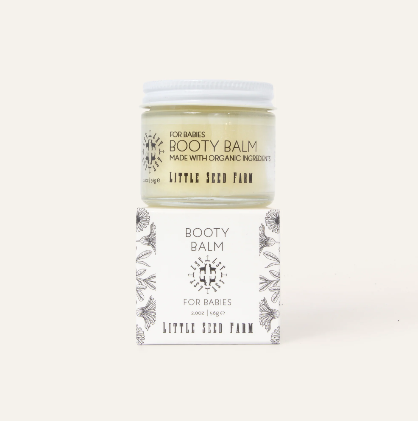 Booty balm jar with packaging on a white background